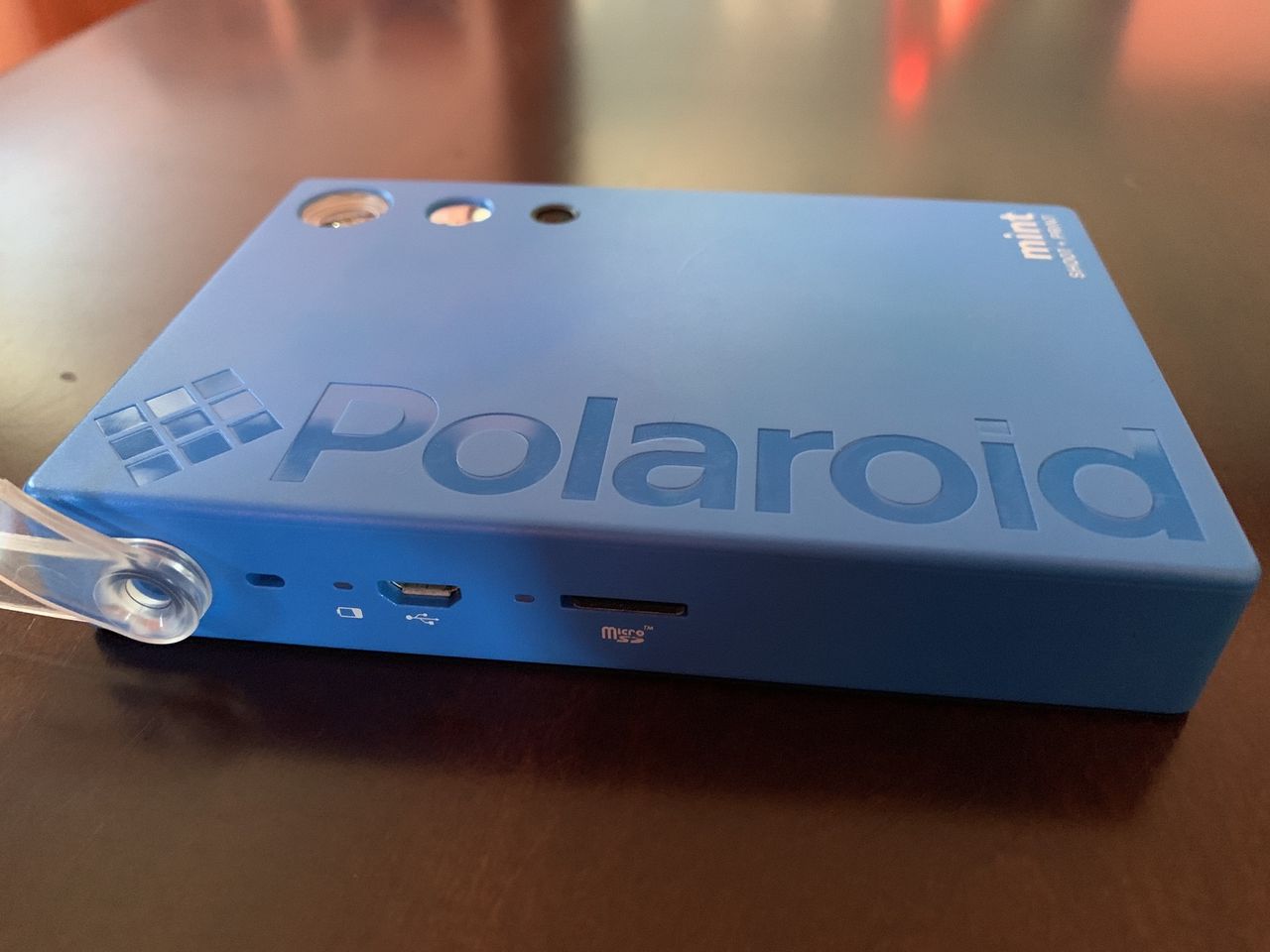 Blue Polaroid Mint Camera &amp; Printer side where the power light and microSD card slot are
