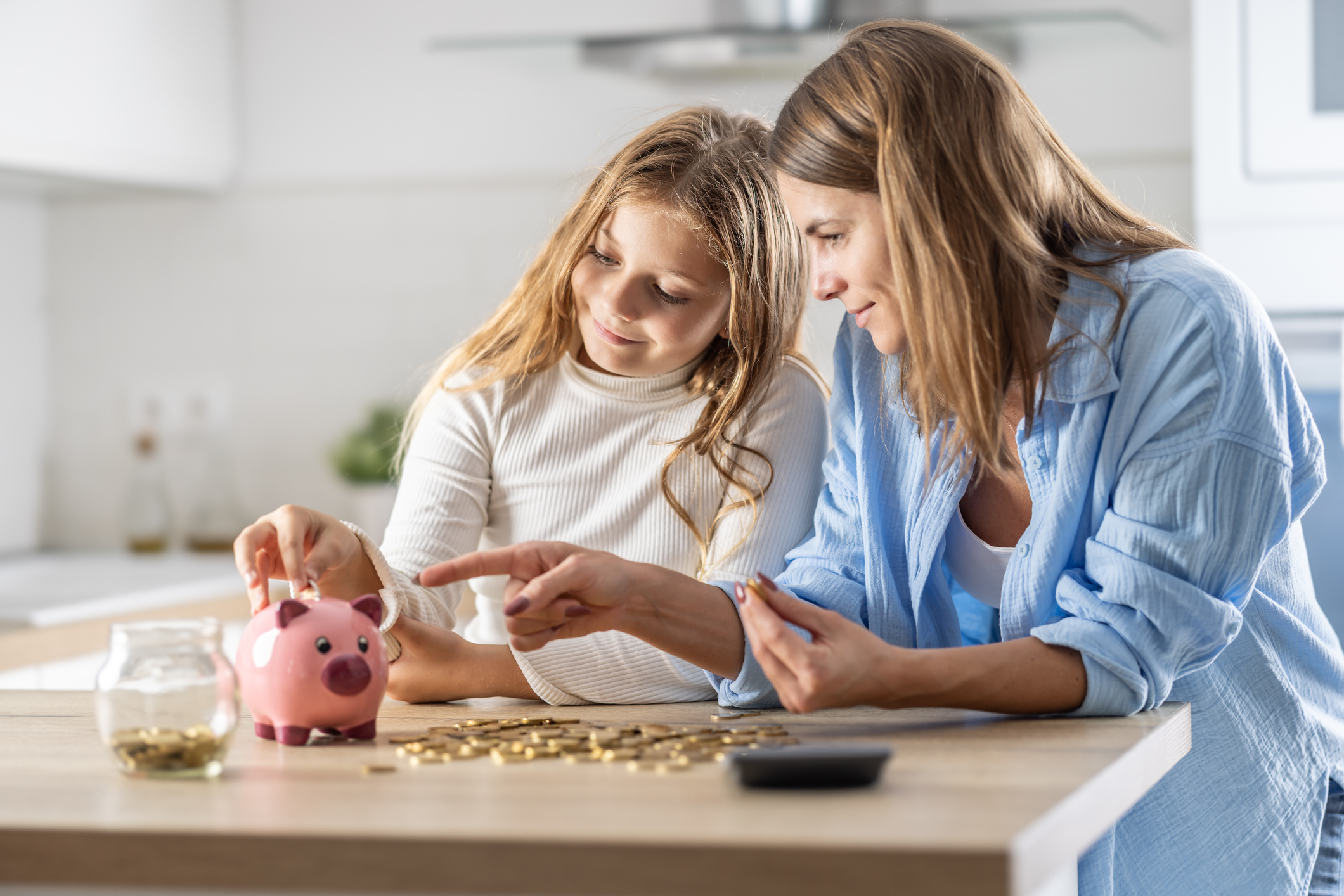 A mother and daughter saving money to put in a Junior ISA
