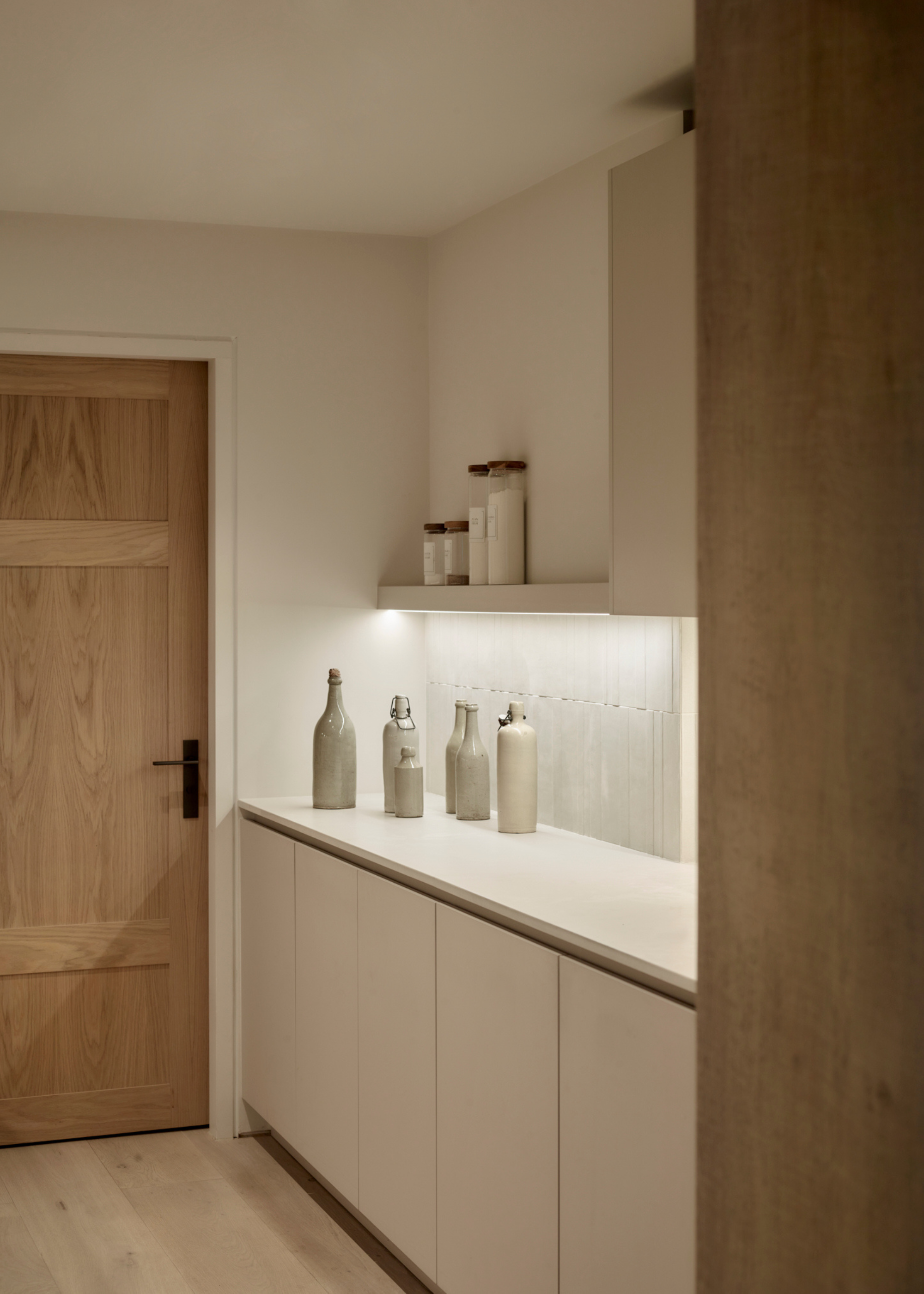 hidden pantry kitchen with simple white cabinets