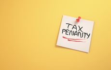 Tax Penalty Text Written on Note Paper Sitting on Yellow Background