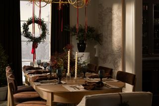 Christmas table decor with festive foliage and candles by McGee & Co