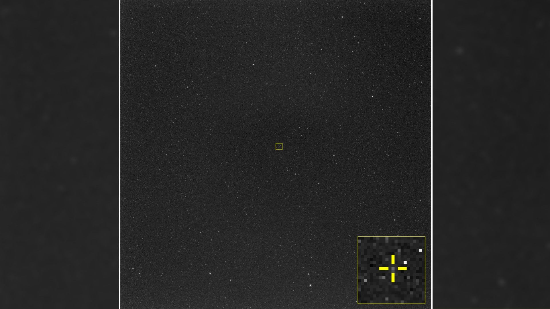 on a starry background, a small yellow crosshairs centers on a small dot