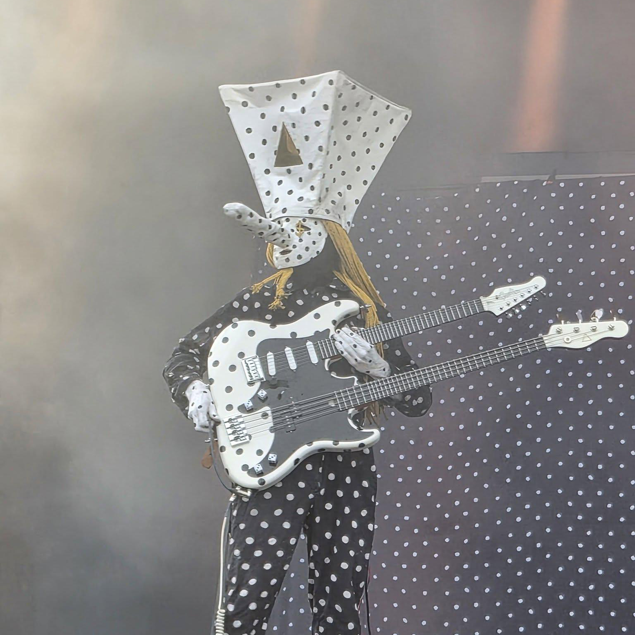 Khn wields his custom Godin Guitars double-neck guitar and bass onstage surrounded by smoke