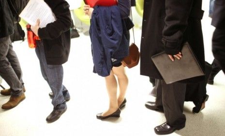 Job seekers wait to speak with potential employers at a job fair in New York last month; the unemployment rate increased, but more jobs were added in April.