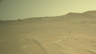 a terrain of red dirt under a reddish-orange sky