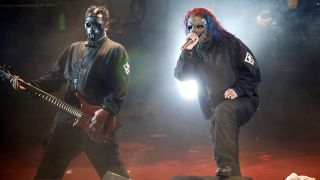 Photo of Paul GRAY and Corey TAYLOR and SLIPKNOT; Paul Gray (L) and Corey Taylor performing on stage