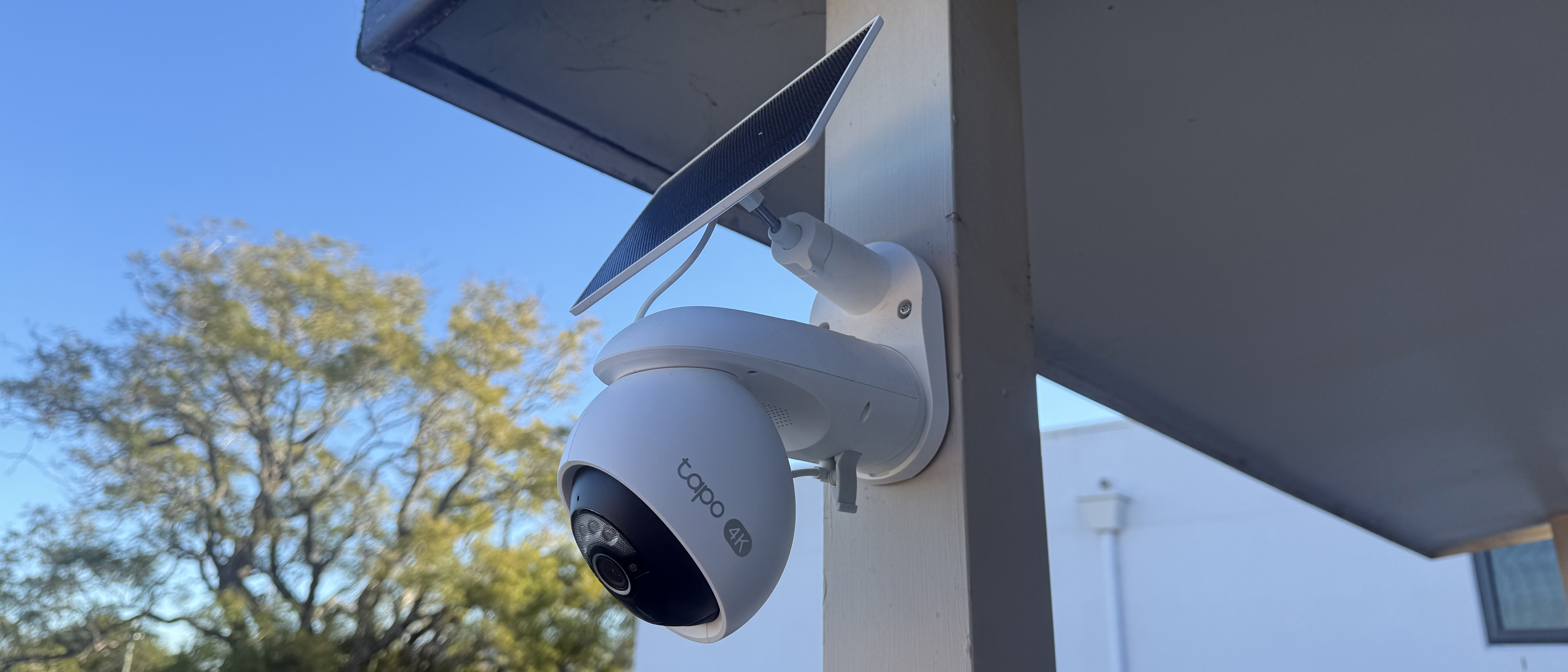 A Tapo C660 Kit security camera mounted on a wooden pole