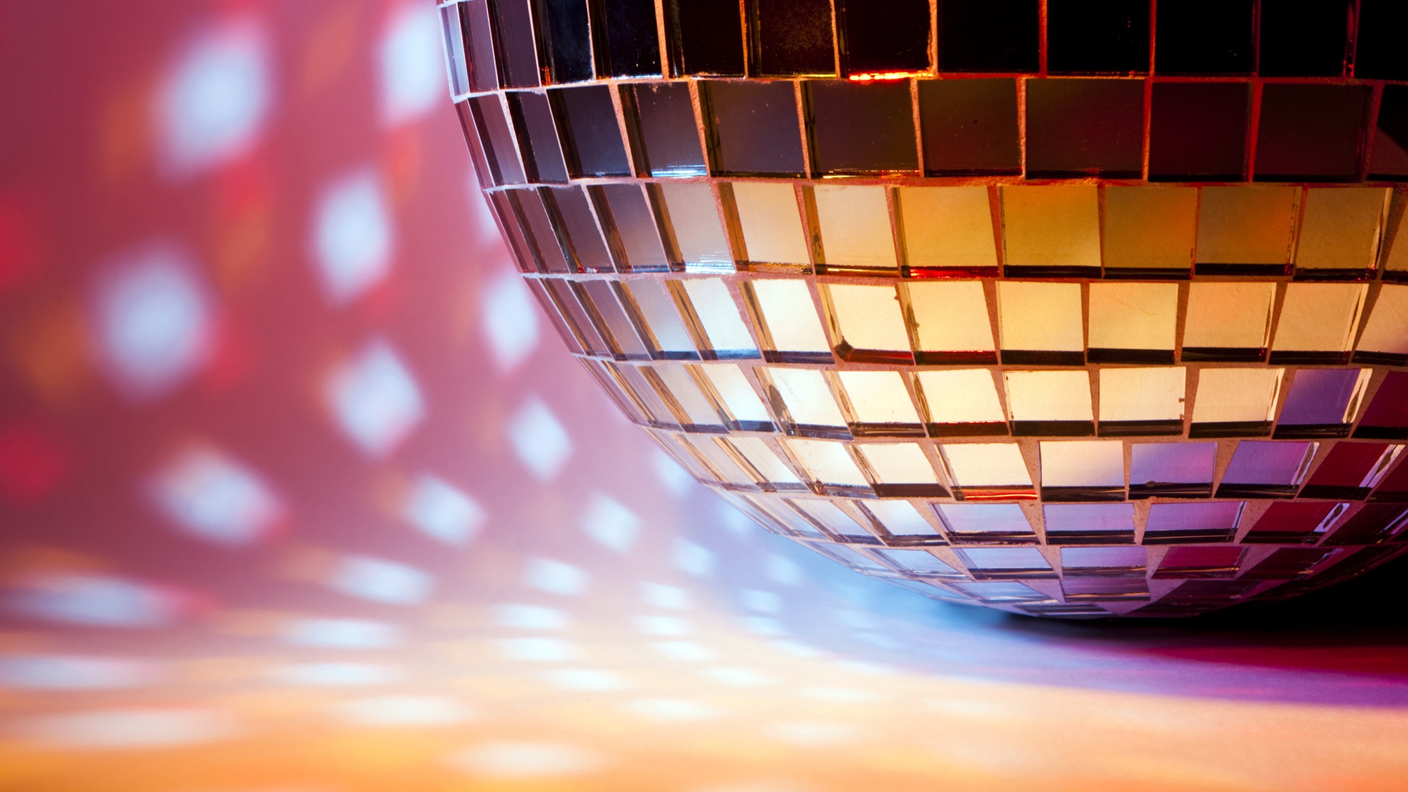 A mirror ball with colored reflection spots.
