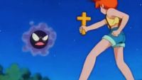 Misty holds up a cross to Ghastly