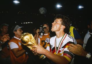 West Germany captain Lothar Matthaus holds the World Cup trophy after victory in the final against Argentina in the 1990 final.