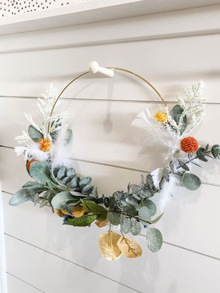 Wreath hanging off DIY accent wall