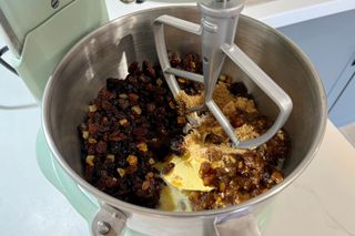 Step-by-step photo of a Christmas cake being baked in an air fryer - step one, mixing the ingredients with a stand mixer