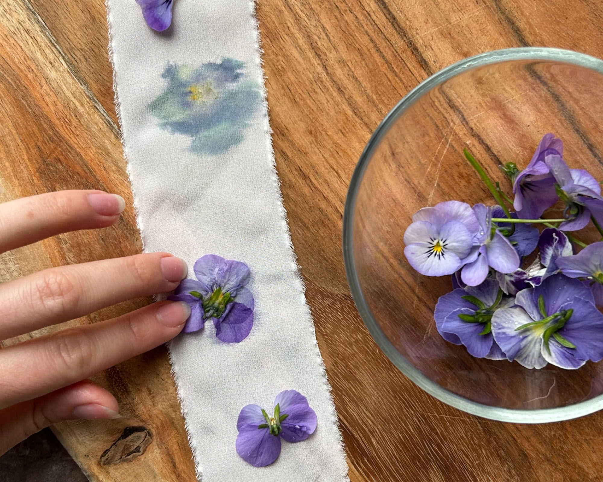 Image shows pansies ready to be hammered to transfer dye onto fabric strip