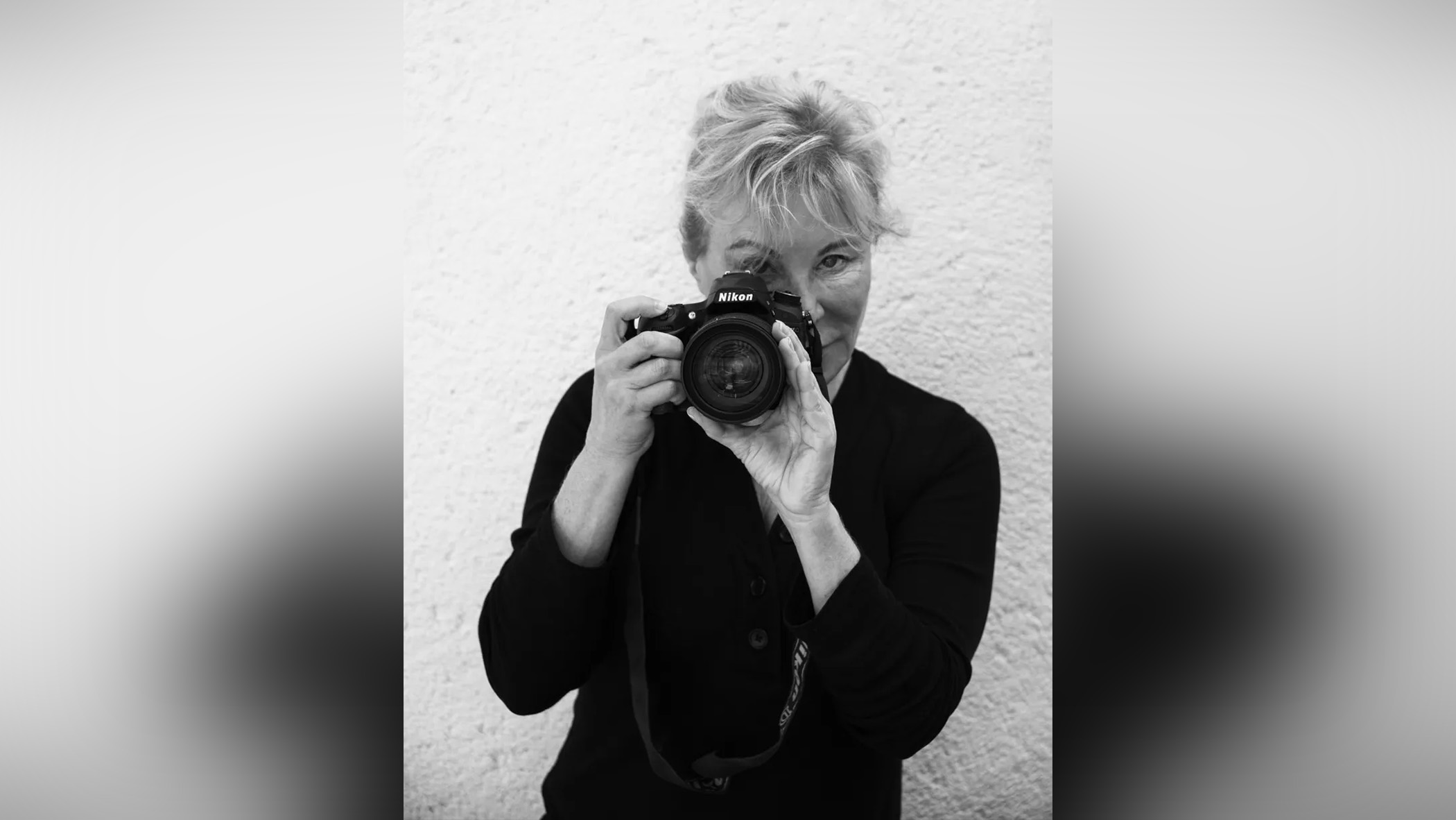 A woman using a camera.