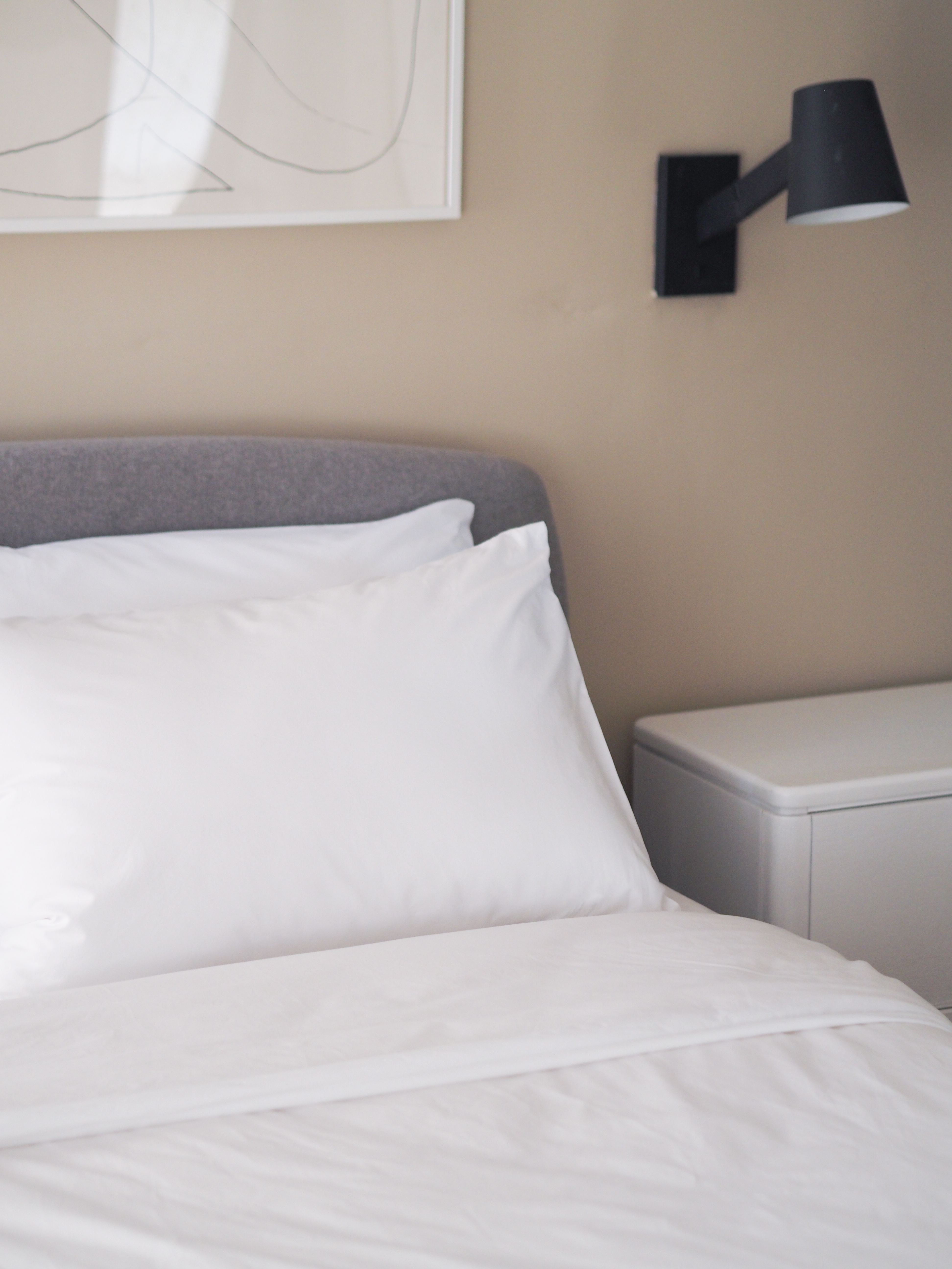 rise and fall white cotton bedding on a bed