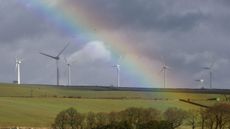 A rainbow illuminates the sky above a wind farm near Sheffield 