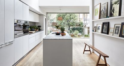 An example of how much does a new kitchen cost showing a white kitchen with a narrow island