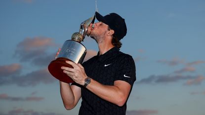 Thomas Pieters kisses the trophy after his victory in the 2022 Abu Dhabi HSBC Championship at Yas Links