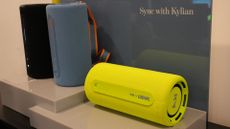 Three Bluetooth speakers sit side by side on a table