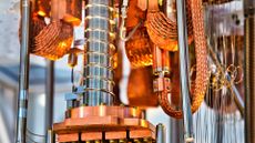 A close-up shot of a working quantum computer, with bronze and silver metal structures and intricate wiring.