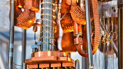 A close-up shot of a working quantum computer, with bronze and silver metal structures and intricate wiring.