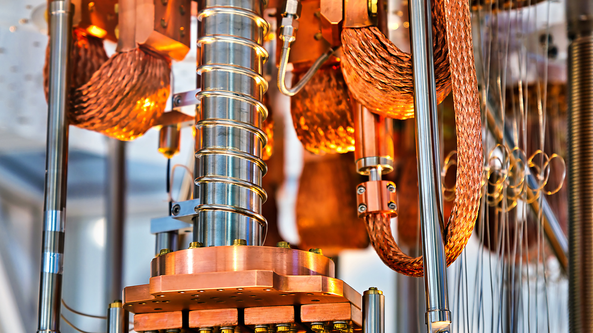 A close-up shot of a working quantum computer, with bronze and silver metal structures and intricate wiring.