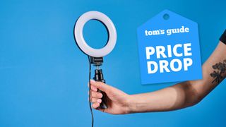 Neewer Basics BR60 5-inch Ring Light photographed in front of a blue background with a price drop tag.
