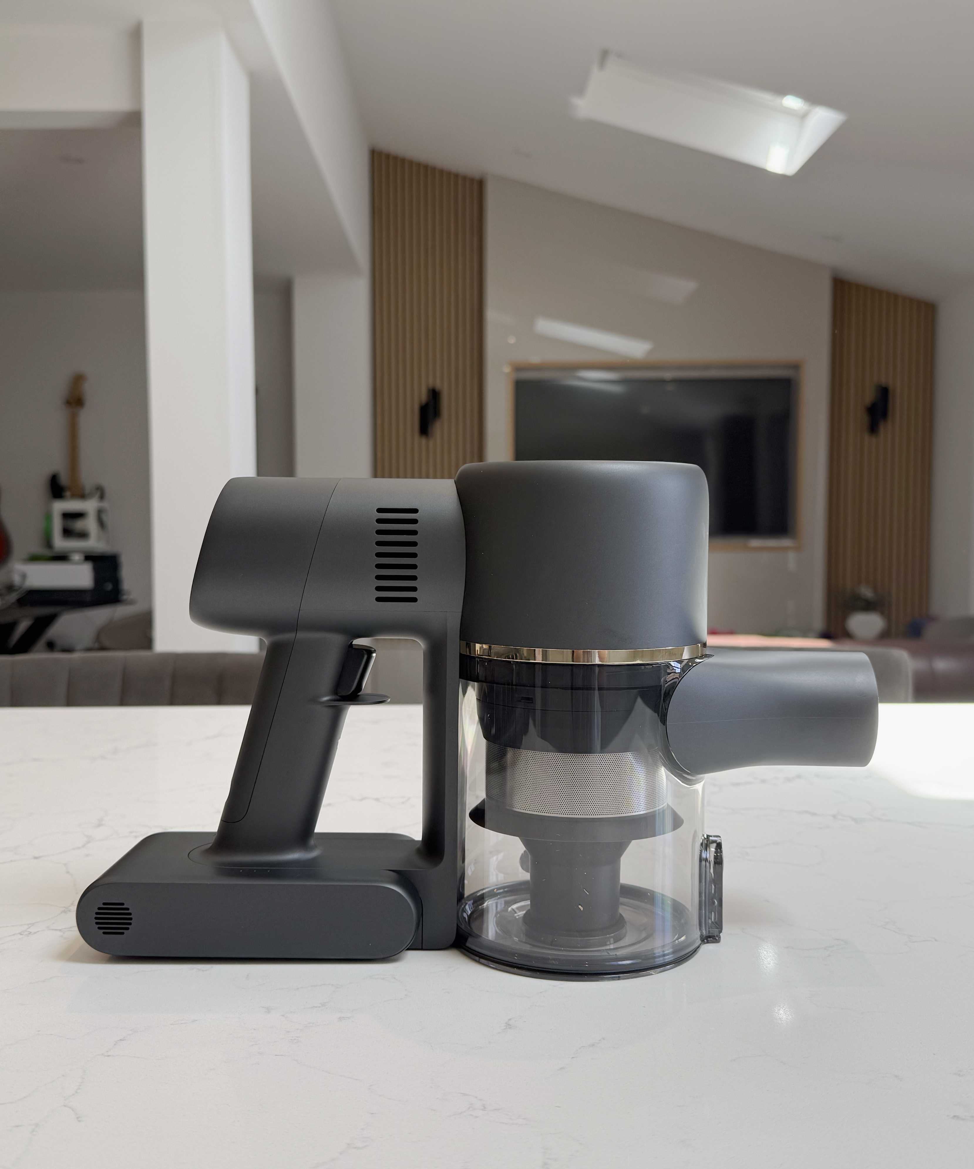 Dreame R10 Pro motor body shown from the side with the dust cup and filter visible