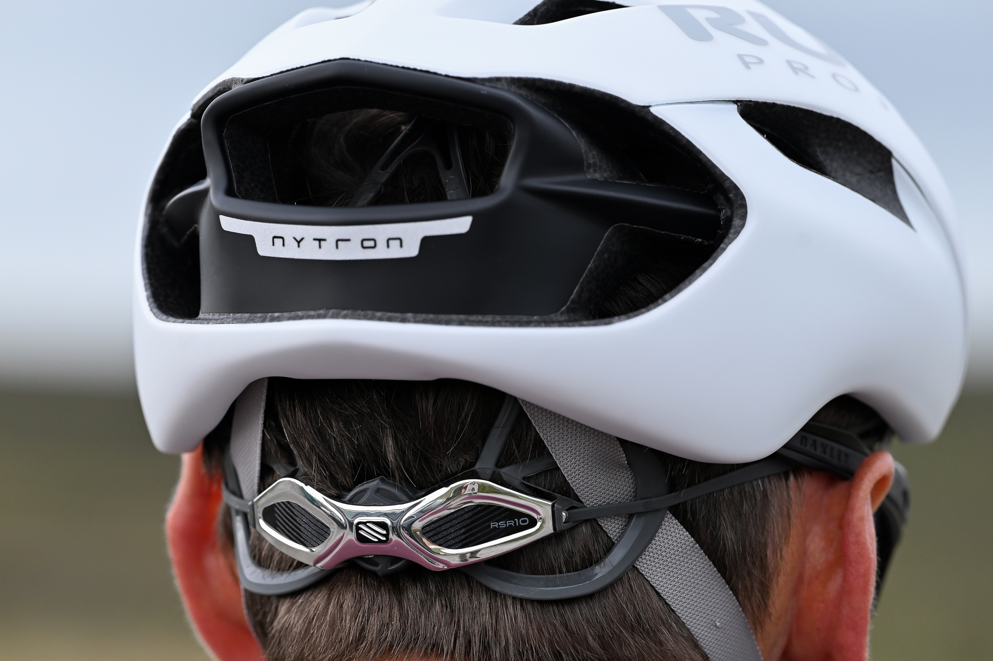 rear view of a man&#039;s head wearing a white helmet