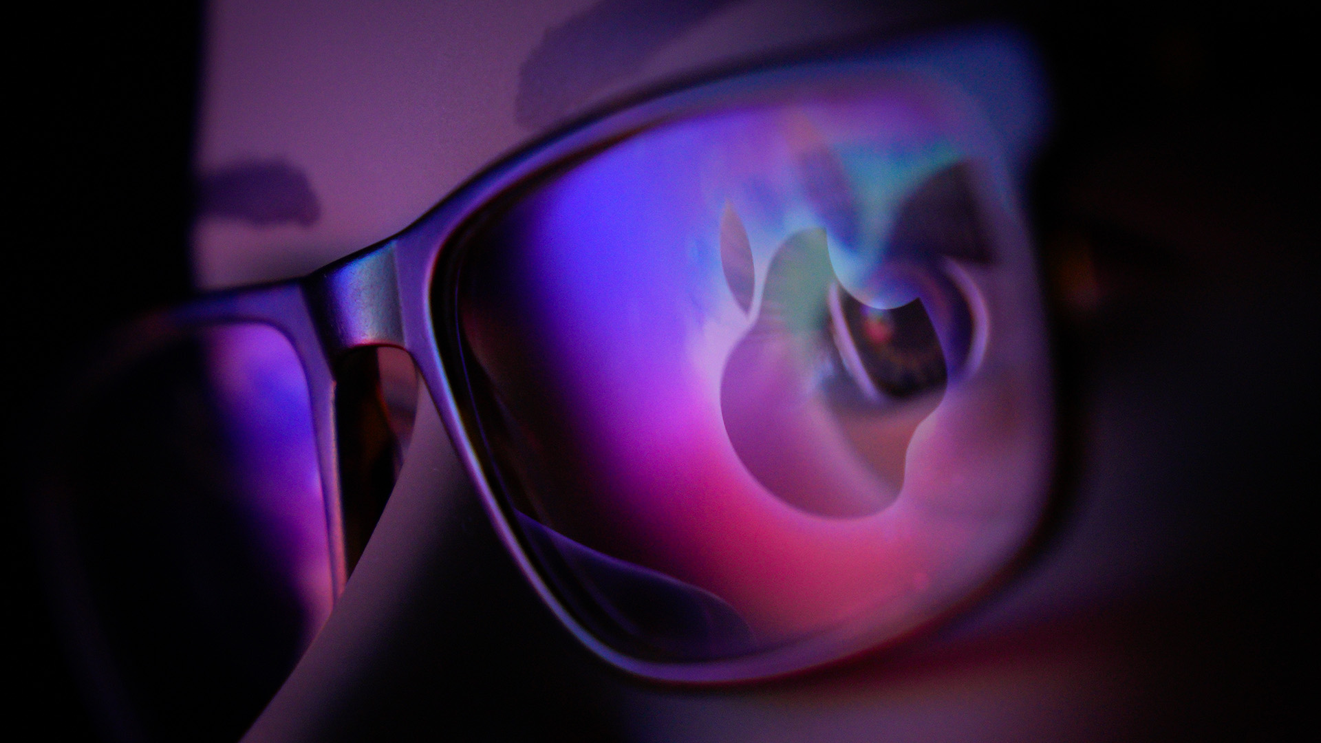 Apple logo in lens of glasses
