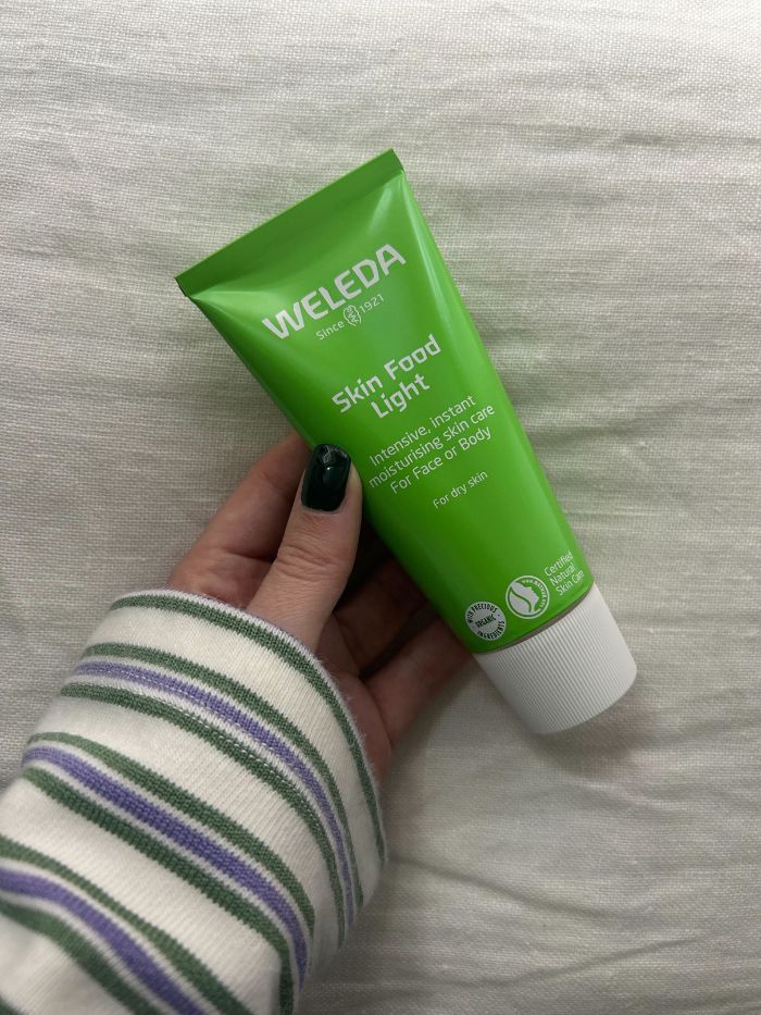 Junior beauty editor Grace Lindsay holding the Weleda Skin Food Light