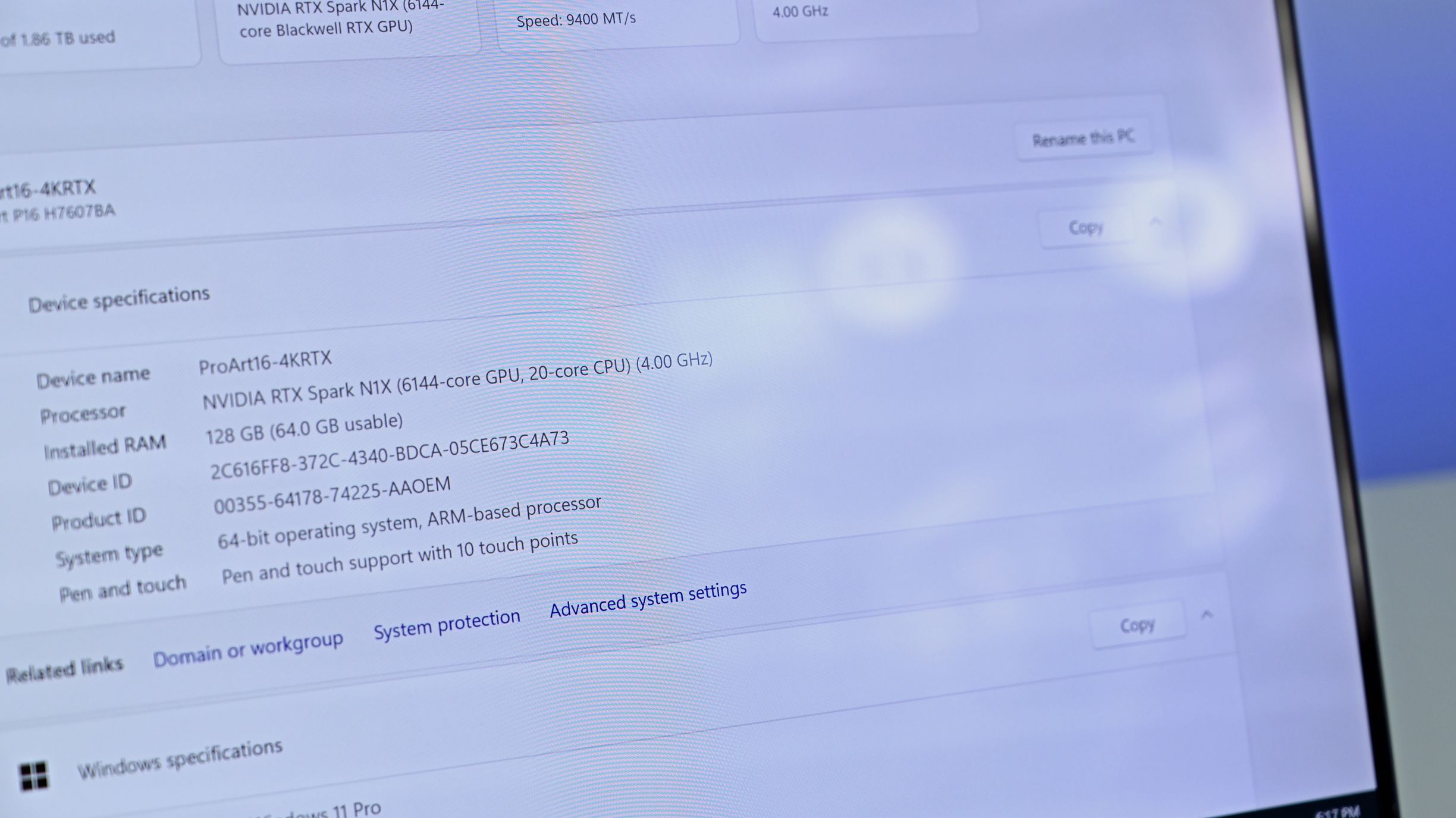 Close-up of the ASUS ProArt P16 4K anti-reflective screen showing Windows specs: NVIDIA RTX Spark N1X and 128 GB RAM, with diffused glare reduction.