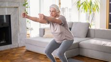 Senior woman exercises at home