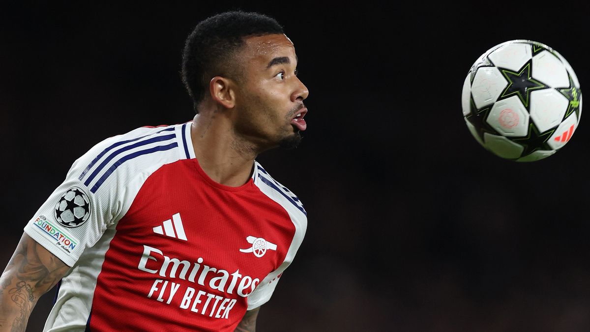 Arsenal&#039;s Gabriel Jesus heads the Champions League football in his red and white home shirt.