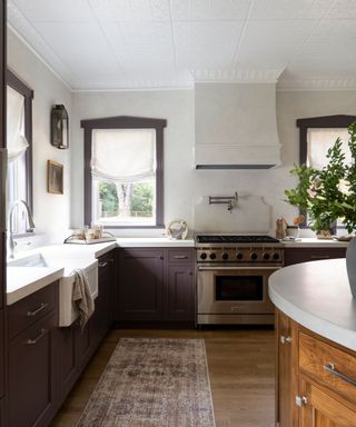 kitchen with purple cabinets and window frames, white walls and ceiling, wooden floor