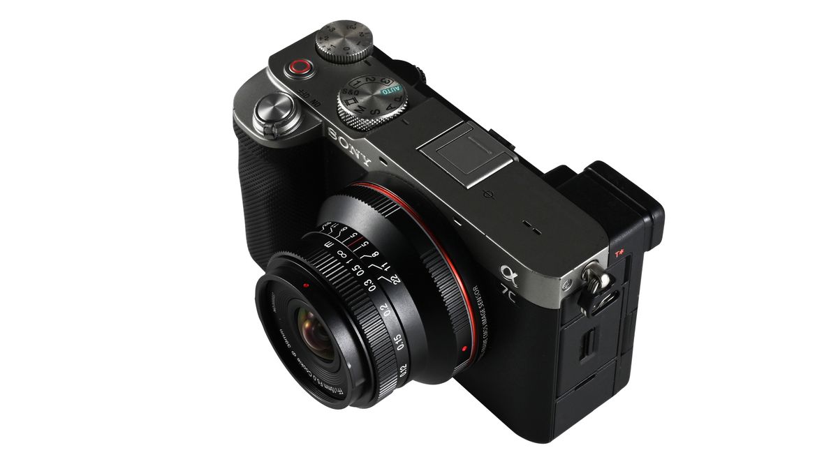Laowa 15mm f/5 Cookie FF lens, mounted to a camera, against a white background