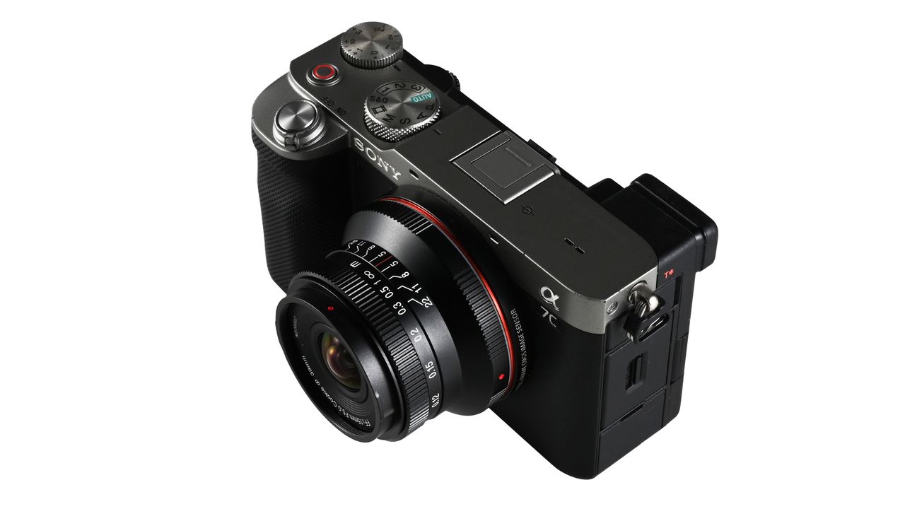 Laowa 15mm f/5 Cookie FF lens, mounted to a camera, against a white background