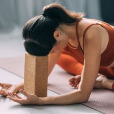 Morning yoga: A woman practicing yoga at home with blocks