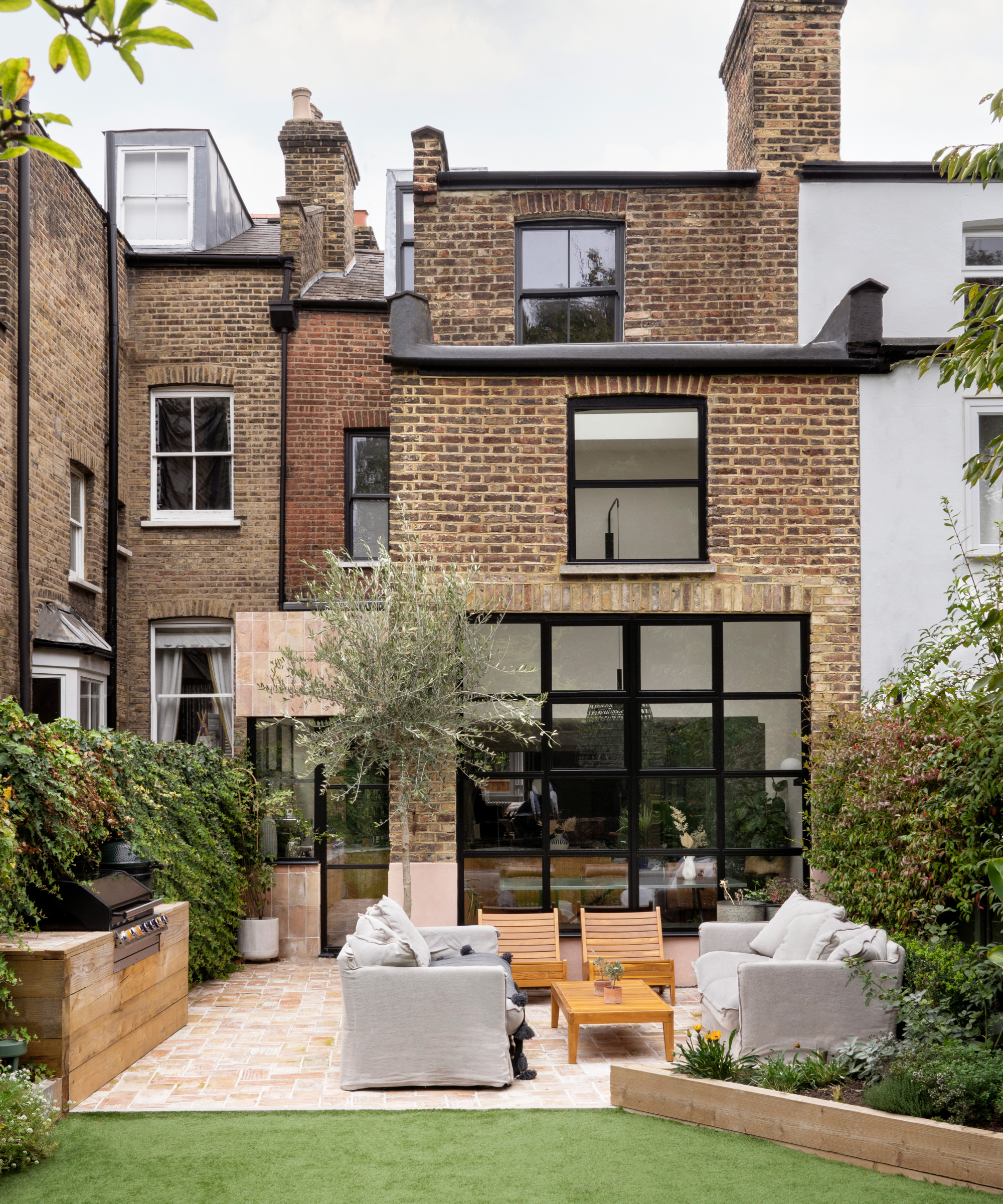 rear double storey and side extension to victorian terraced house with side extension clad in tiles, remainder built from brick