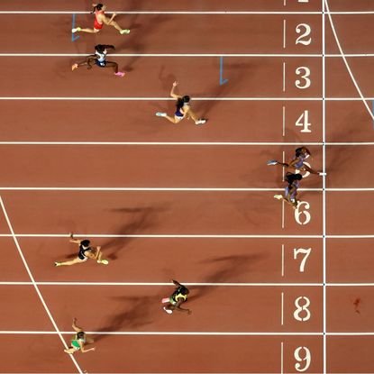 Female athletes crossing the finish line at a track and field event
