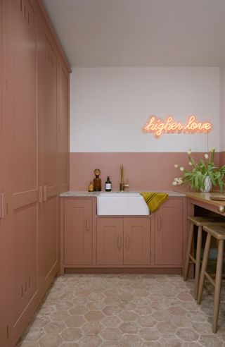 pink narrow utility room ideas with neon light above a butler a sink