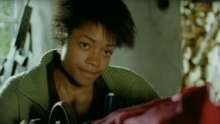 Naomie Harris works a sewing machine in 28 Days Later's alternate ending.