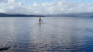 Woman paddleboarding in the Lake District