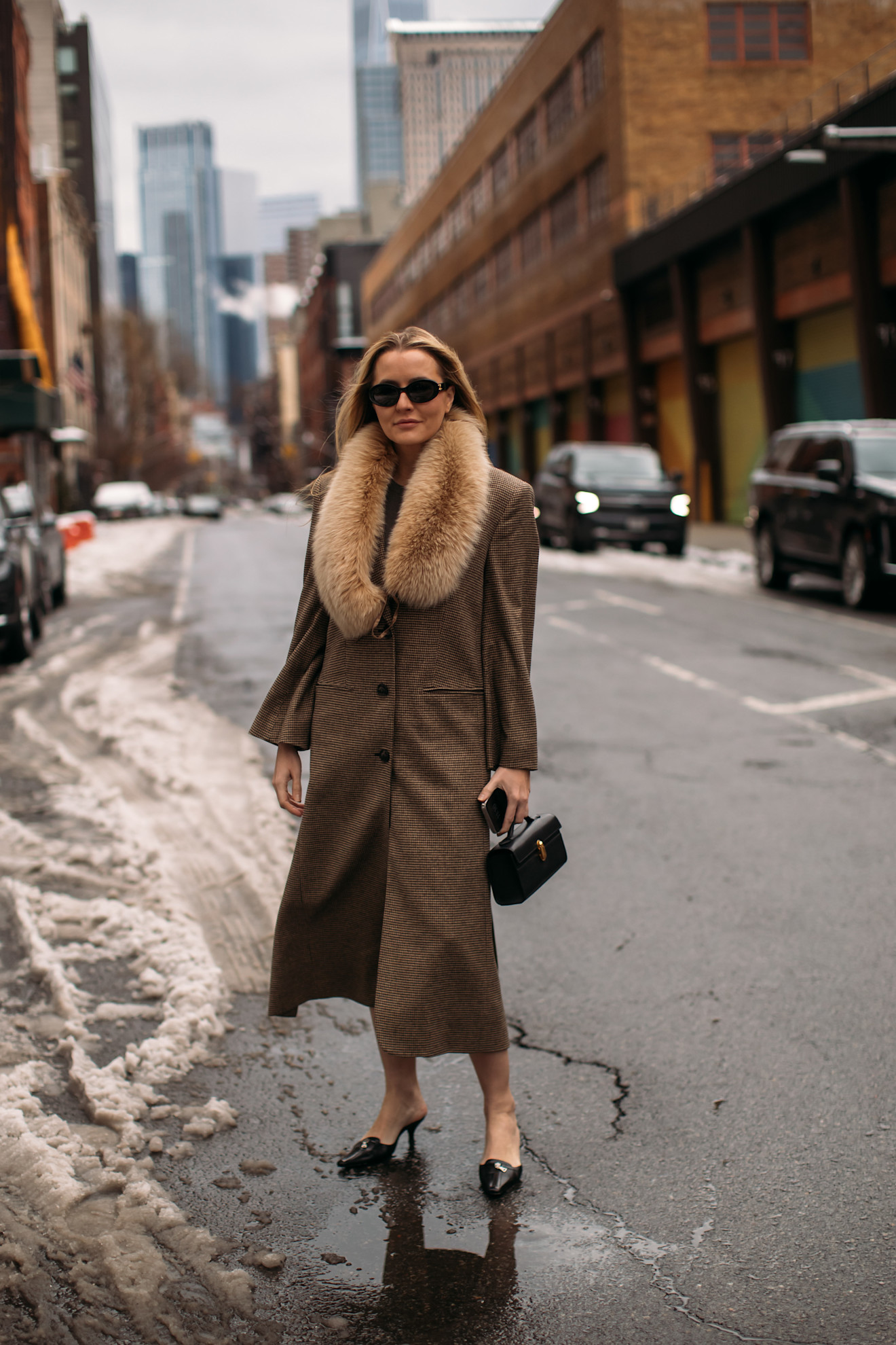 Fur accessory trend is shown in a street style photo of a woman