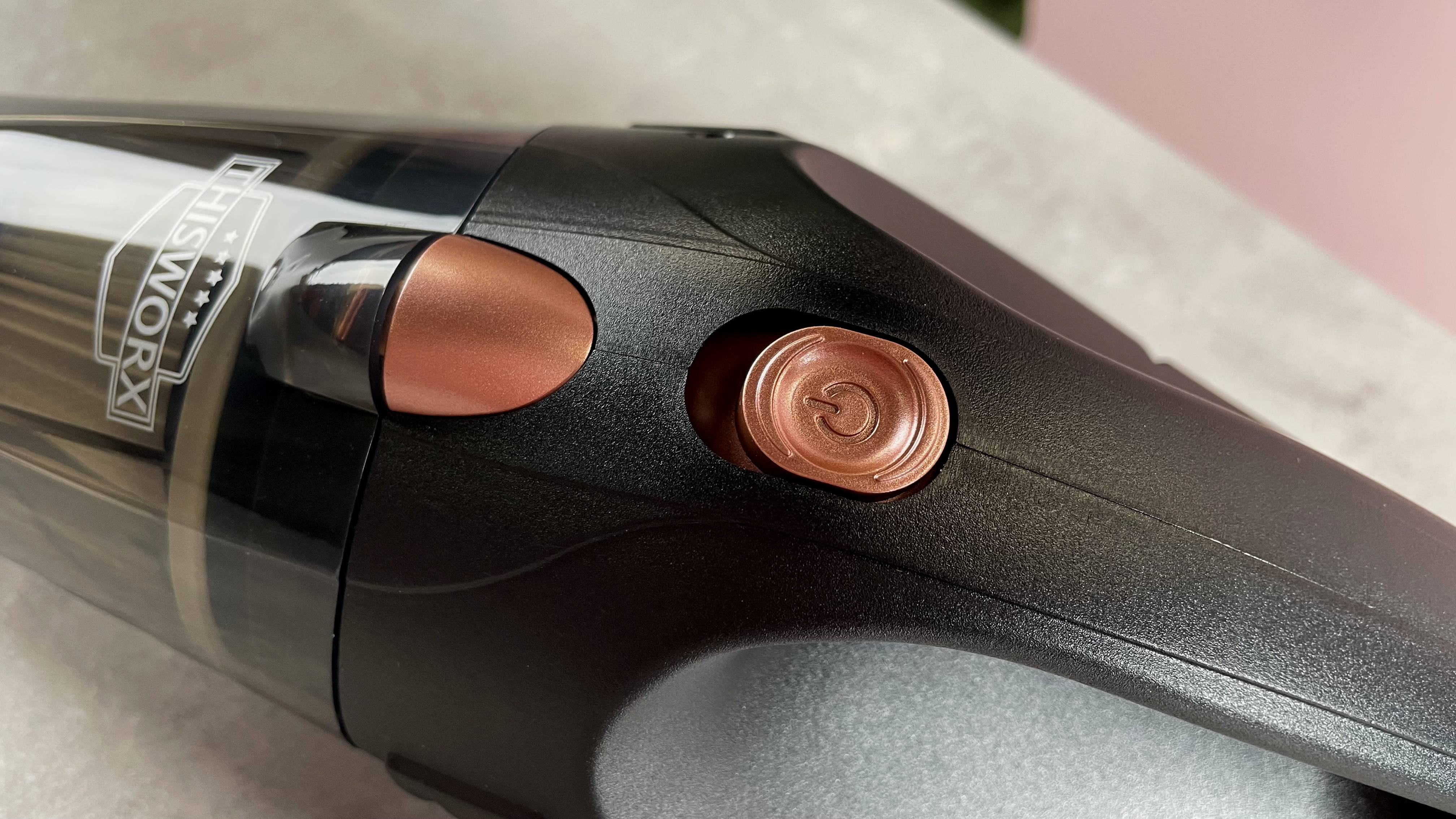 Close-up of rose gold power button and dustproof cup.