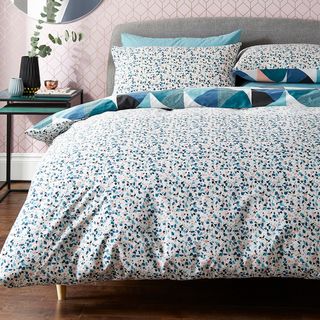 bedroom with bed having printed dotted bedding set