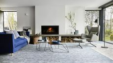 A light textured carpet in a modern living room with a fireplace insert