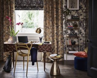 Maximalist home office by John Lewis and Partners, with patterned wallpaper, patterned curtains, and patterned blinds, a desk with a geometric chair, and a bronze side table