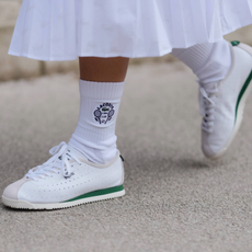 PARIS, FRANCE - MARCH 09: A guest wears white socks, white sneaker shoes, outside Lacoste, during the Paris Fashion week Women's Fall/Winter 2025-2026 on March 9, 2025 in Paris, France. (Photo by Edward Berthelot/Getty Images)