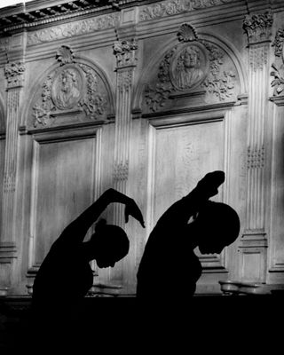 Silhouettes of dancers on abbey wall